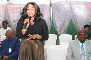 Managing Director Rural Electrification Agency, Damilola Ogunbiyi,(middle )during her Opening remark at the Signing of Contract Agreement of the Year 2017 Capital Projects ,While Director of Project REA, Engr. Bolakale Kawu (right) and Director of Procurement ,Mr Charles Ngene looks with admiration .