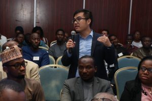 Workshop participant asking questions during the breakout session on mini grid tender (2)
