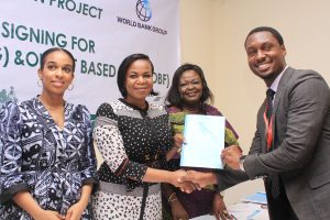 L-R, Component Head SHS ,REA, Ifunanya Nwandu-Dozie, MD-CEO Rural Electrification Agency, Damilola Ogunbiyi ,Head Project Management Unit, REA ,Adejoke Odumosu and Marketing Manager Solar by Dlight,Mr Gerald Omani receiving a copy of the Signed Grant Agreement during the event