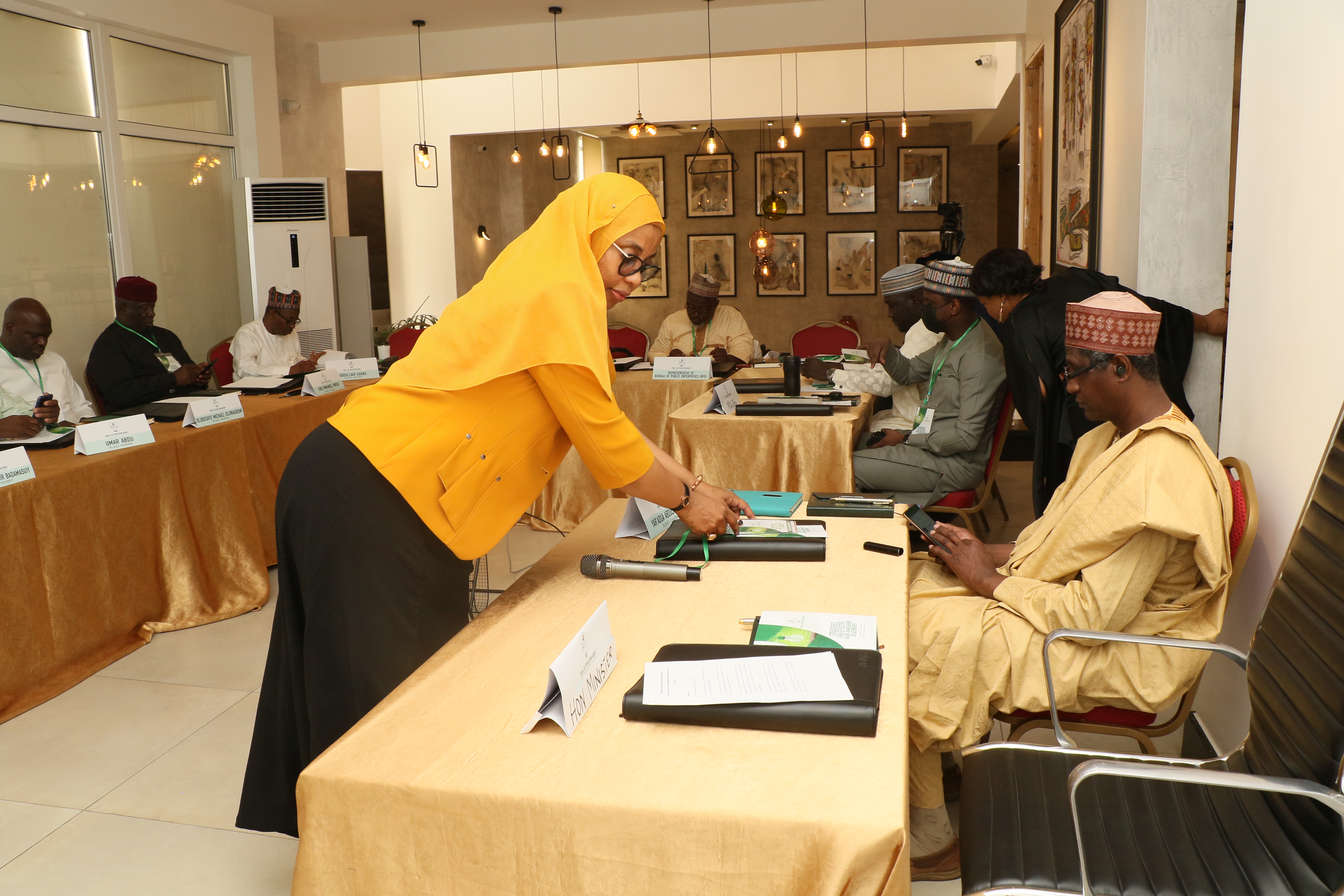 -L-R, Hajia Amina Sugha, Director Legal,REA, registering the Board Chairman REA ,Musa Abdulaziz Yar’Adua