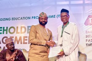 Olufemi Akinyelure - Head, Nigeria Electrification Project, and Prof. Ali Ishaq Shugaba - Deputy Vice-Chancellor (Academics), University of Lafia, shake hands and proudly display the signed Collaboration Agreement